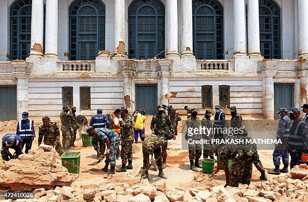 Nepalese army, police and local work together to clear rubble along a street of Durbar Square, a UNESCO world heritage site in Kathmandu, following...