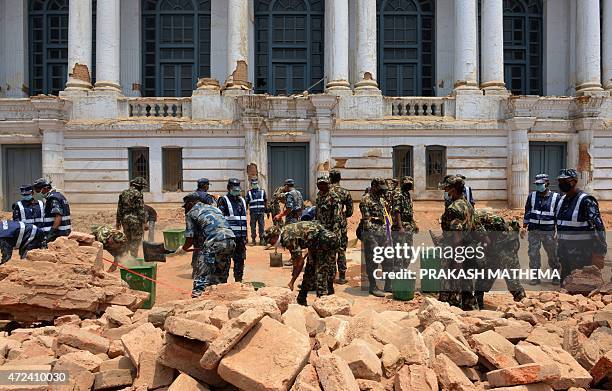 Nepalese army, police and local work together to clear rubble along a street of Durbar Square, a UNESCO world heritage site in Kathmandu, following...