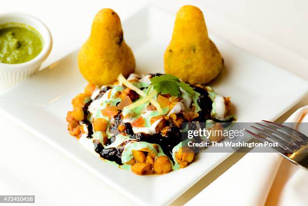 Laliguras Restaurants Aloo Tikki Potato patties served with spiced chickpeas and yogurt sauce.