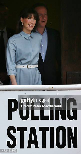 Prime Minister David Cameron is led by his wife Samantha as they leave a polling station after casting their vote in the general election on May 6,...