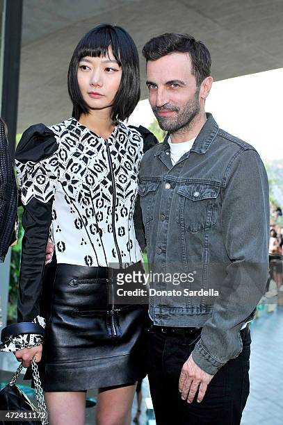 Actress Doona Bae and designer Nicolas Ghesquiere backstage at the Louis Vuitton Cruise 2016 Resort Collection shown at a private residence on May 6,...