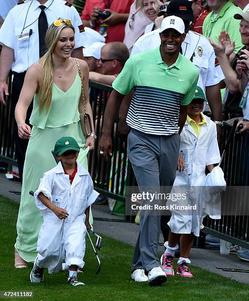 Tiger Woods of the United States walks with his girlfriend Lindsey Vonn, son Charlie and daughter Sam during the par 3 contest prior to the start of...