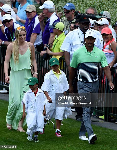 Tiger Woods of the United States walks with his girlfriend Lindsey Vonn, son Charlie and daughter Sam during the par 3 contest prior to the start of...