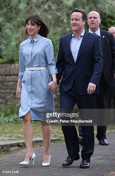 Prime Minister David Cameron and his wife Samantha arrive at a polling station to cast their vote in the general election on May 6, 2015 in...