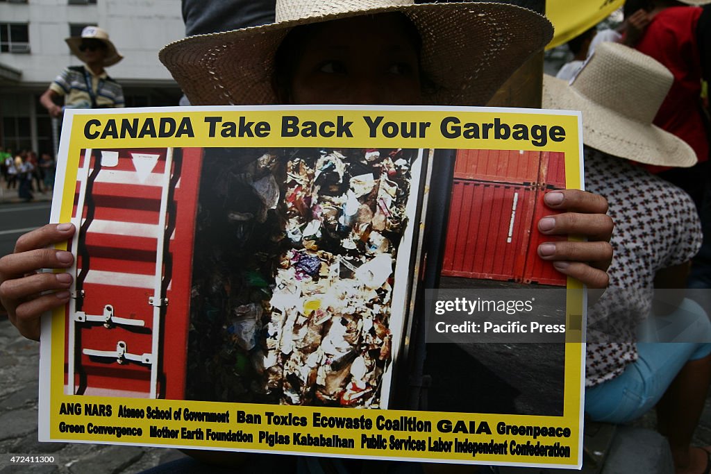 A protesters holding a poster of the shipping container in...