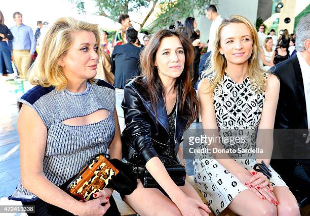 Actresses Catherine Deneuve and Charlotte Gainsbourg, and Director and executive vice president of Louis Vuitton Delphine Arnault attend the Louis...