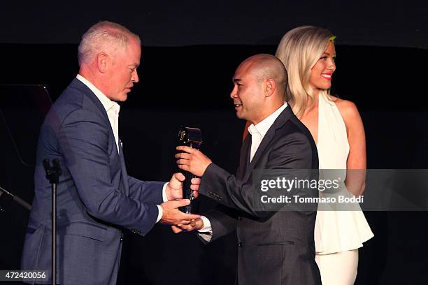 Actor Neal McDonough honors Winner of the Golden Trailer Award for Best Documentary Trailer creative director Scott Mitsui on stage during the 16th...