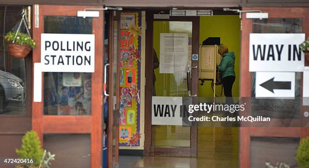 Woman casts her vote as polling gets under way at the Glen Road polling station on May 7, 2015 in Belfast, Northern Ireland. The United Kingdom has...