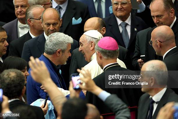 Pope Francis greets Italian actor Pino Insegno as he arrives at the Paul VI Hall for an audience with the Societa Sportiva Lazio on May 7, 2015 in...