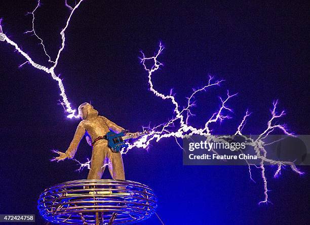 Man in an iron mesh suit plays with man-made lightening during a show on April 29, 2015 in Changle, China. Former electronics engineer Wang Zengxiang...