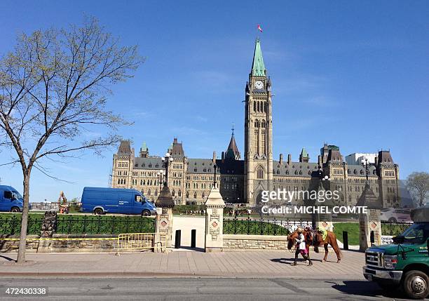 Welsh equestrian Megan Lewis walks her horse past Canada's parliament on May 7, 2015 in Ottawa, Ontario. She is on the last leg of a six-year around...