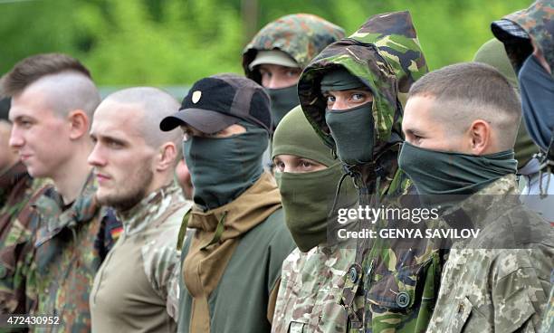 Volunteers of Ukrainian Azov regiment attend a ceremony before their departure to the east of Ukraine after taking part in trainings at their base in...