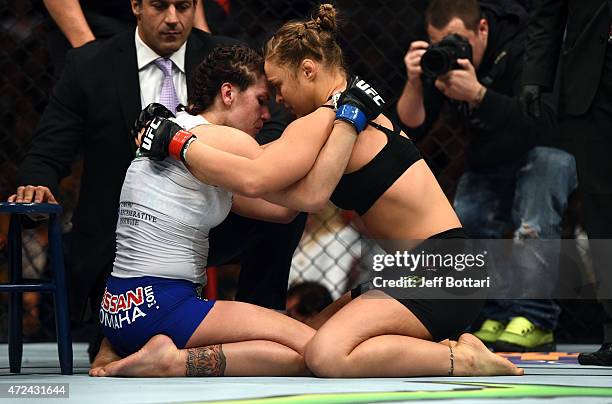 Ronda Rousey consoles Cat Zingano after Rousey defeated her by armbar submission in their UFC women's bantamweight championship bout during the UFC...