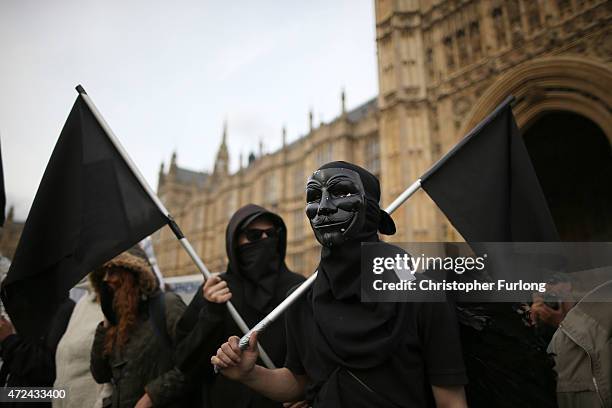 Demonstrators carry black flags during a protest at Parliament Square on election day on May 7, 2015 in London, England. The United Kingdom has gone...