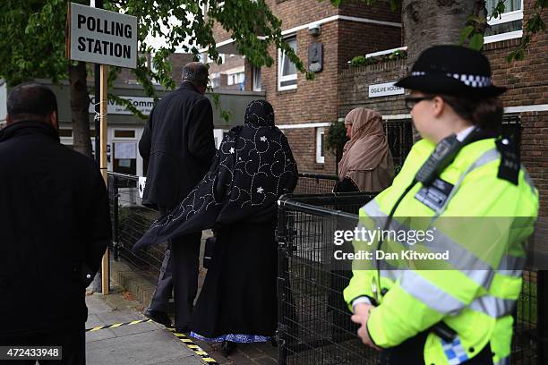 Police officer stands outside a polling station at a community hall in Tower Hamlets on May 7, 2015 in London, England. Police officers have been in...