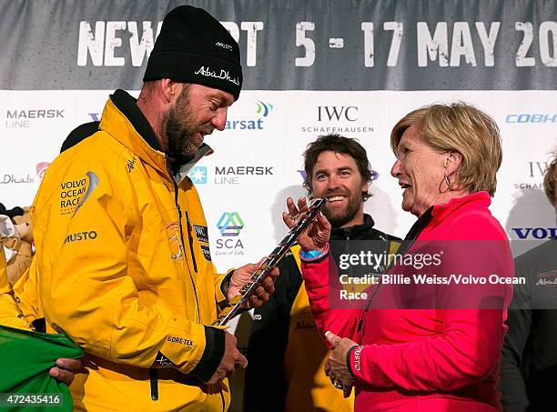 In this handout image provided by the Volvo Ocean Race, Abu Dhabi boat captain Ian Walker is presented with the second place trophy by Newport Mayor...