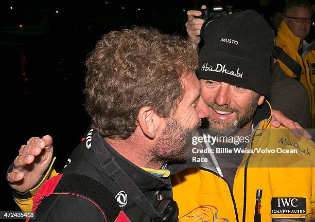 In this handout image provided by the Volvo Ocean Race, Abu Dhabi boat captain Ian Walker greets DongFeng boat captain Graham Tourell during the...