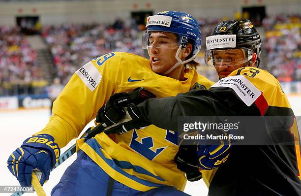 Victor Rask of Sweden is hold by Stephan Daschner of Germany during the IIHF World Championship group A match between Sweden and Germany at o2 Arena...