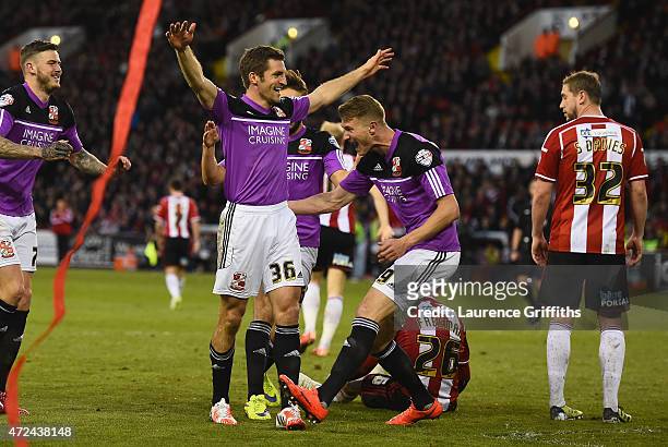 Sam Ricketts of Swindon Town is mobbed after the equalising goal during the Sky Bet League One playoff semi final match between Sheffield United and...