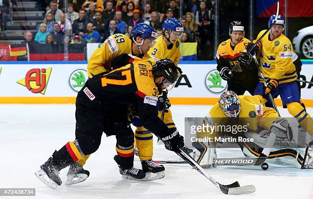 Jhonas Enroth , goaltender of Sweden saves the shot of Patrick Reimer of Germany during the IIHF World Championship group A match between Sweden and...
