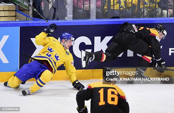 Forward Simon Hjalmarsson of Sweden falls after a tackle with defender Patrick Koppchen of Germany during the group A preliminary round match Sweden...