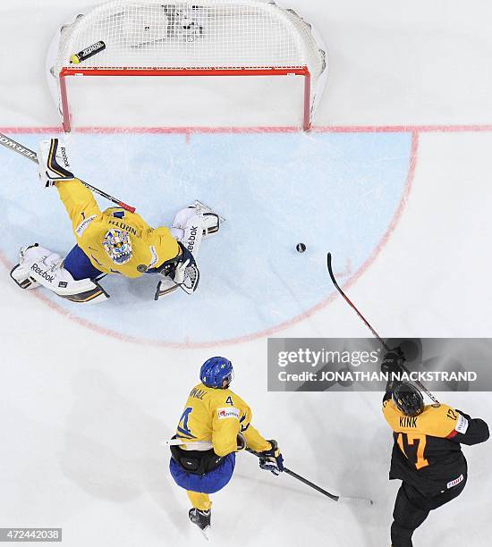 Forward Marcus Kink of Germany shoots to score past goalkeeper Jhonas Enroth of Sweden during the group A preliminary round match Sweden vs Germany...