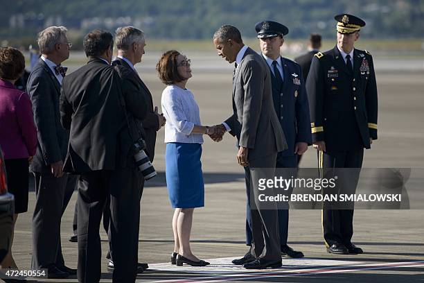 President Barack Obama is greeted by Oregon Governor Kate Brown at the Oregon Air National Guard Base May 7, 2015 in Portland, Oregon. AFP...