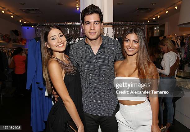 Angela Rincon, Danilo Carrera and Maria Elena Davila pose at Studio LX during the clothing launch of Chiquinquira Delgado in collaboration with David...