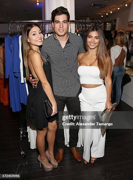 Angela Rincon, Danilo Carrera and Maria Elena Davila pose at Studio LX during the clothing launch of Chiquinquira Delgado in collaboration with David...