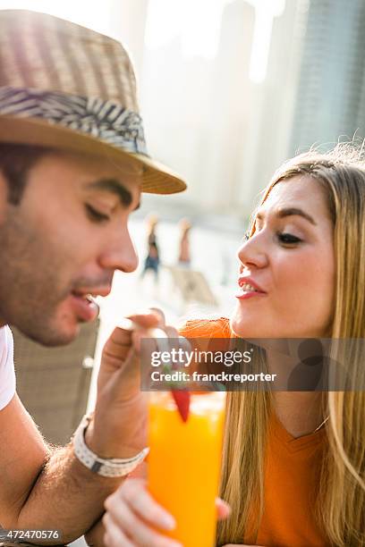 couple refreshment at cafe in dubai marina - strohoed stockfoto's en -beelden