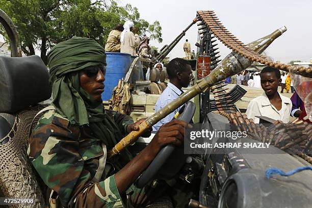 Fighter from the Sudanese Rapid Support Forces sits in an armed vehicle in the city of Nyala, in south Darfur, on May 3 as they display weapons and...