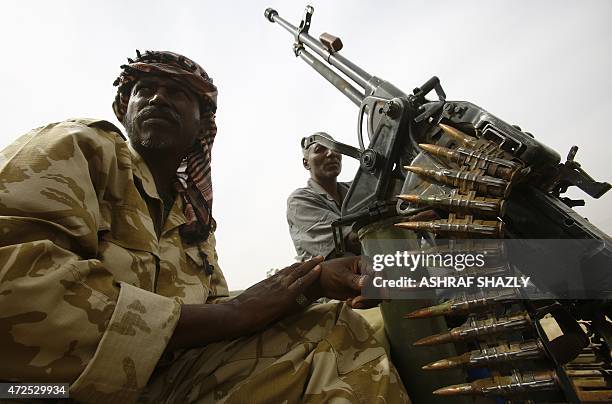 Fighters from the Sudanese Rapid Support Forces sit on an armed vehicle in the city of Nyala, in south Darfur, on May 3 as they display weapons and...