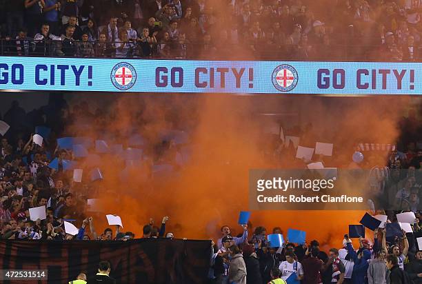 Melbourne City fans set off a flare during the A-League semi final match between Melbourne Victory and Melbourne City at Etihad Stadium on May 8,...