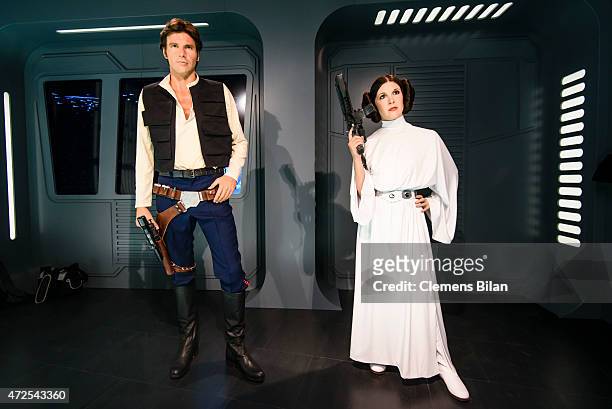Wax figures of the actors Harrisson Ford as the Star Wars character Han Solo and Carrie Fisher in her role of Leia Organa are displayed on the...