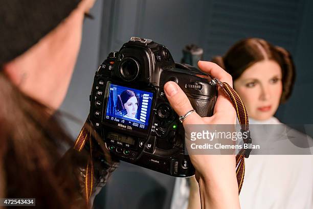 Journalist films a wax figure of the actress Carrie Fisher as the Star Wars character Leia Organa displayed on the occasion of Madame Tussauds Berlin...