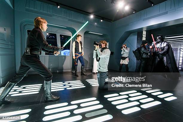 Journalists take pictures of wax figures of the actors Mark Hamill as the Star Wars character Luke Skywalker, Harrison Ford as the Star Wars...