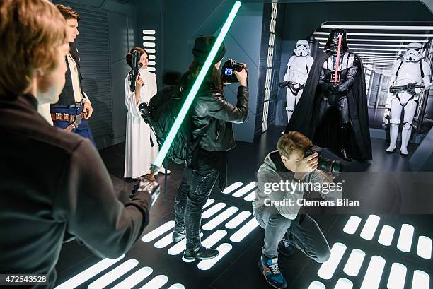 Journalists take pictures of wax figures of the actors Mark Hamill as the Star Wars character Luke Skywalker, Harrison Ford as the Star Wars...