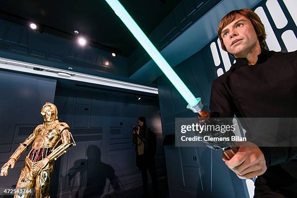 Wax figure of the actor Mark Hamill as the Star Wars character Luke Skywalker and the Star Wars robot character C-3PO are displayed on the occasion...