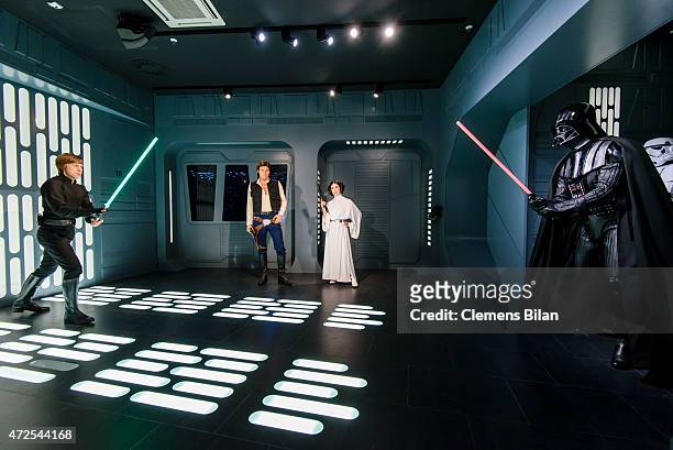 Wax figures of Mark Hamill as the Star Wars character Luke Skywalker, Harrison Ford as the Star Wars character Han Solo, Carrie Fisher as the Star...