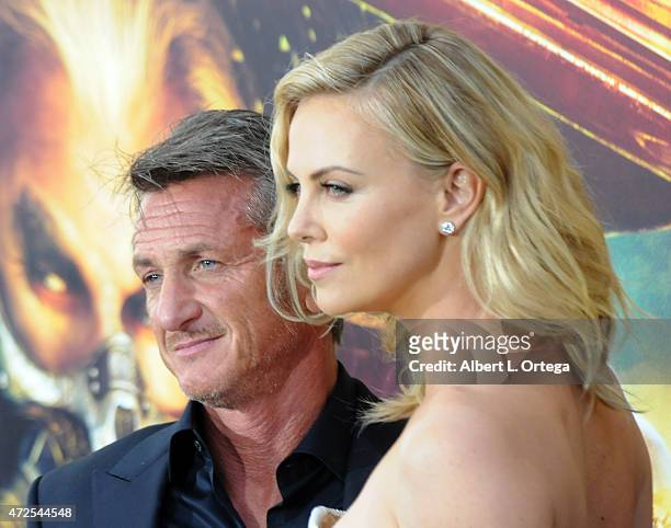 Actor Sean Penn and actress Charlize Theron arrive for the Premiere Of Warner Bros. Pictures' "Mad Max: Fury Road" held at TCL Chinese Theatre on May...