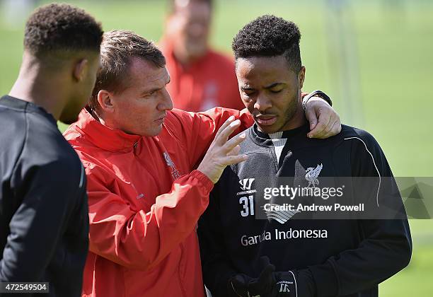 Brendan Rodgers manager of Liverpool talks with Raheem Sterling during a training session at Melwood Training Ground on May 8, 2015 in Liverpool,...