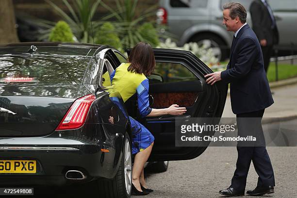 Prime Minister David Cameron opens the car door for his wife Samantha as they leave 10 Downing Street for Windsor Palace to meet with Queen Elizabeth...
