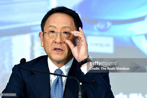 Toyota Motor Co President Akio Toyoda adjusts his glasses during the press conference announcing the fiscal 2014 financial result at Toyota's Tokyo...