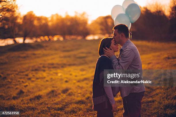 the tree of us - balloon stomach stockfoto's en -beelden