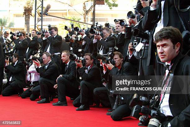 Photographers take picture of movie stars on the red carpet of the palais des festivals during the 55th Cannes film festival 24 May 2002. AFP PHOTO...