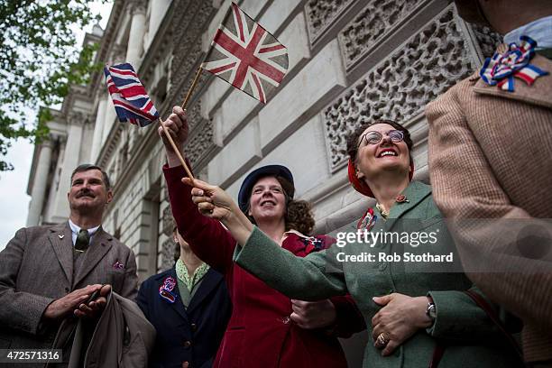 Members of the public wave Union Flags during a tribute at the Cenotaph to begin three days of national commemorations to mark the 70th anniversary...