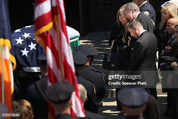 Family members grieve as the casket for fallen New York City police officer Brian Moore is brought into a Long Island church on May 8, 2015 in...