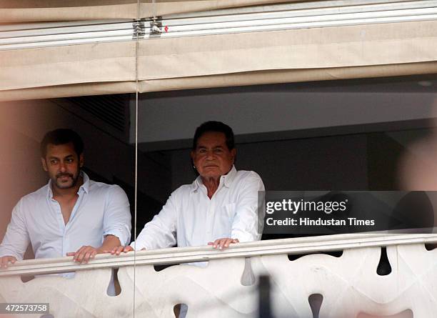 Bollywood actor Salman Khan and his father Salim Khan greets to fans from the balcony of their Bandra home after furnishing bail in the 2002...