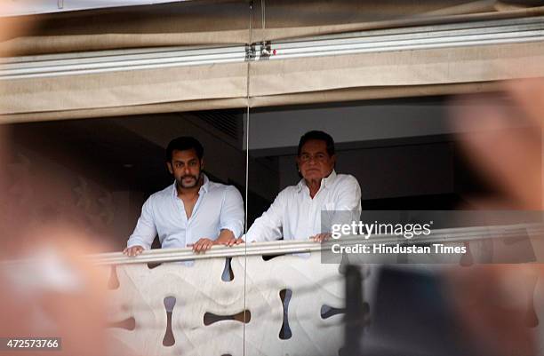 Bollywood actor Salman Khan and his father Salim Khan greets to fans from the balcony of their Bandra home after furnishing bail in the 2002...