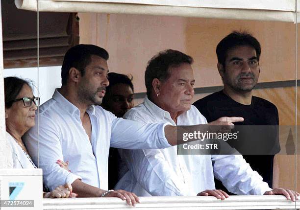 Indian Bollywood actor Salman Khan , mother Salma, , father Salim Khan and Arbaaz Khan stand on the balcony on arrival at his house in Galaxy...